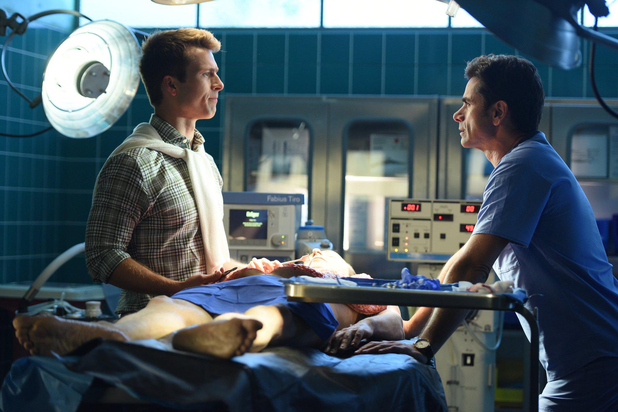 John Stamos and Glen Powell in Scream Queens (2015)