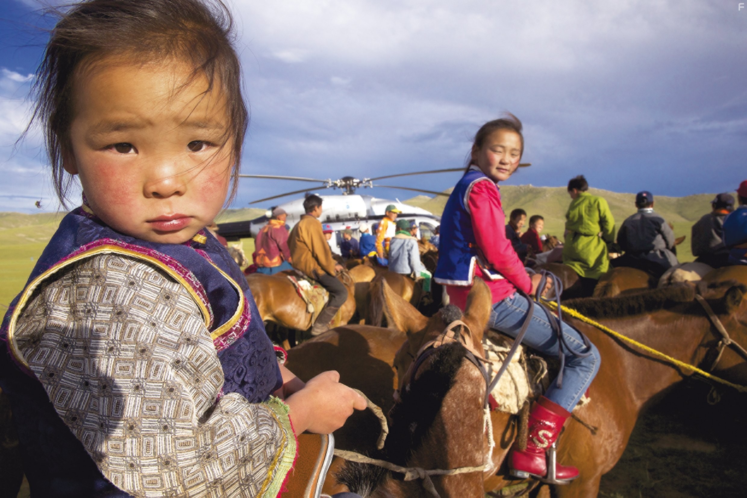 An EC145 helicopter in Mongolia, in the middle of some young semi-nomadic people preparing for a horse race.