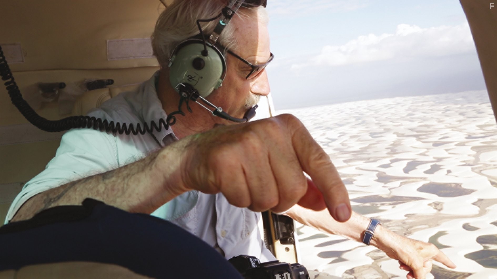 Yann Arthus-Bertrand gives directions during a shoot in Brazil, over the national park of Lenc?o?is Maranhenses.