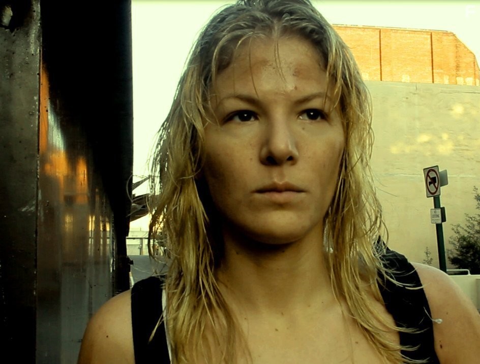 Diedre searches for shelter and survivors in the zombie apocalyptic film , One Last Sunset Redux.