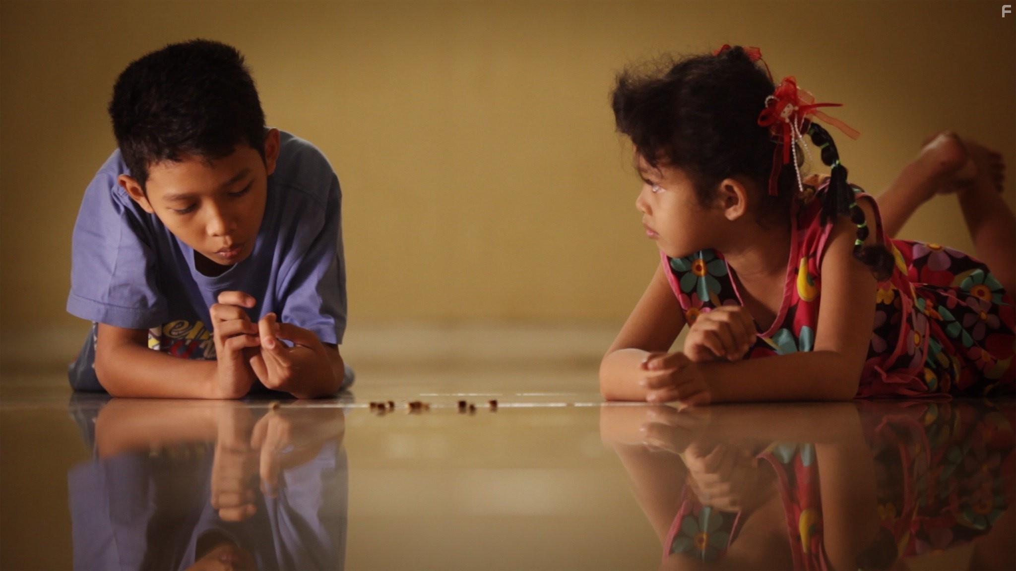Adi’s children play with jumping beans.