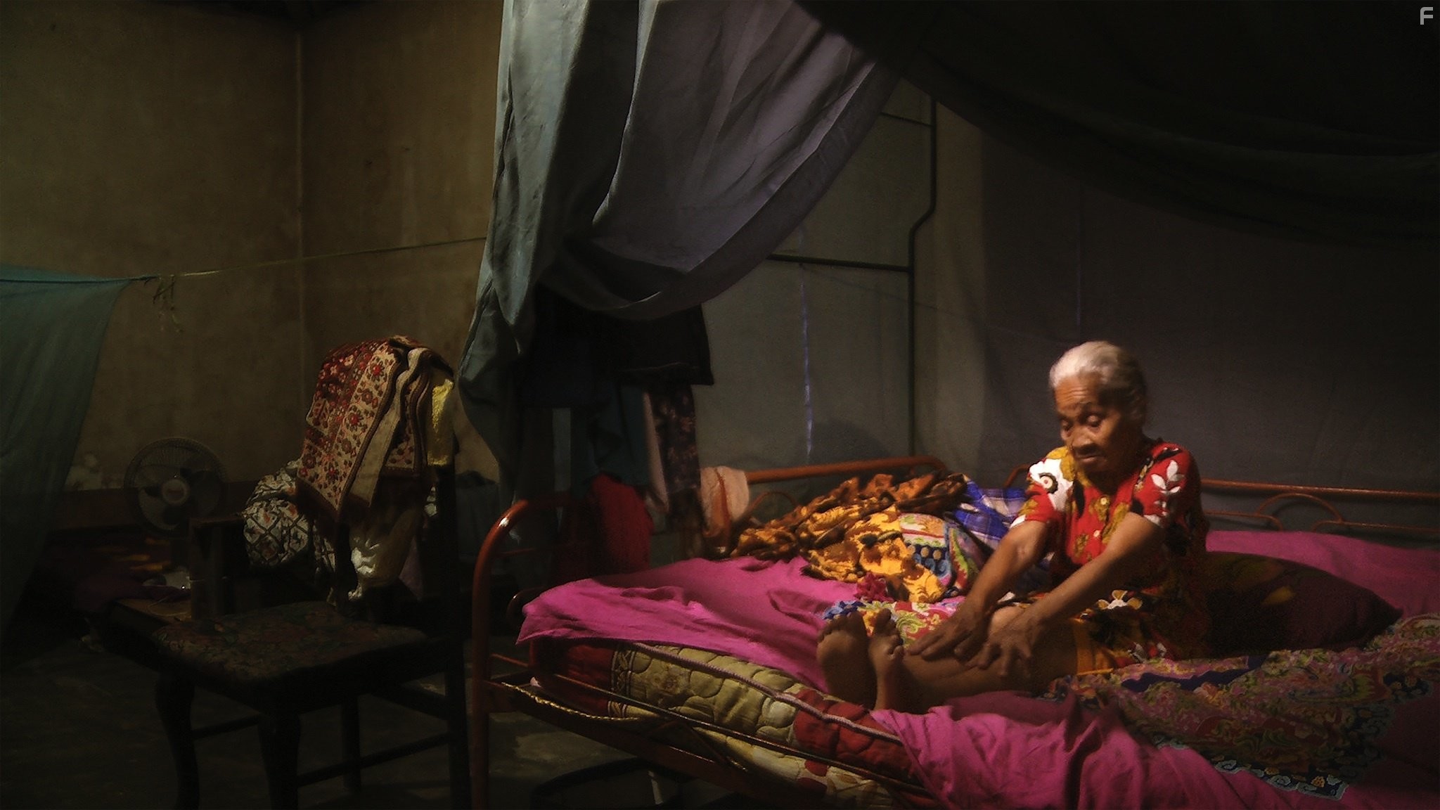 Adi’s mother, Rohani, stretches her weary body.