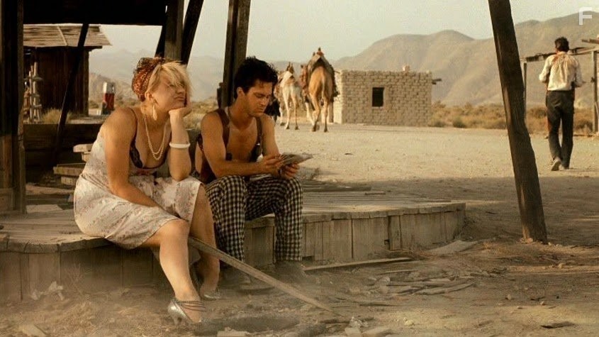 Courtney Love and Dick Rude in Прямо в ад (1986)