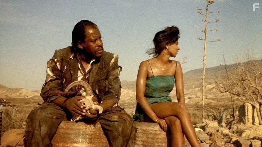 Jennifer Balgobin and Sy Richardson in Прямо в ад (1986)