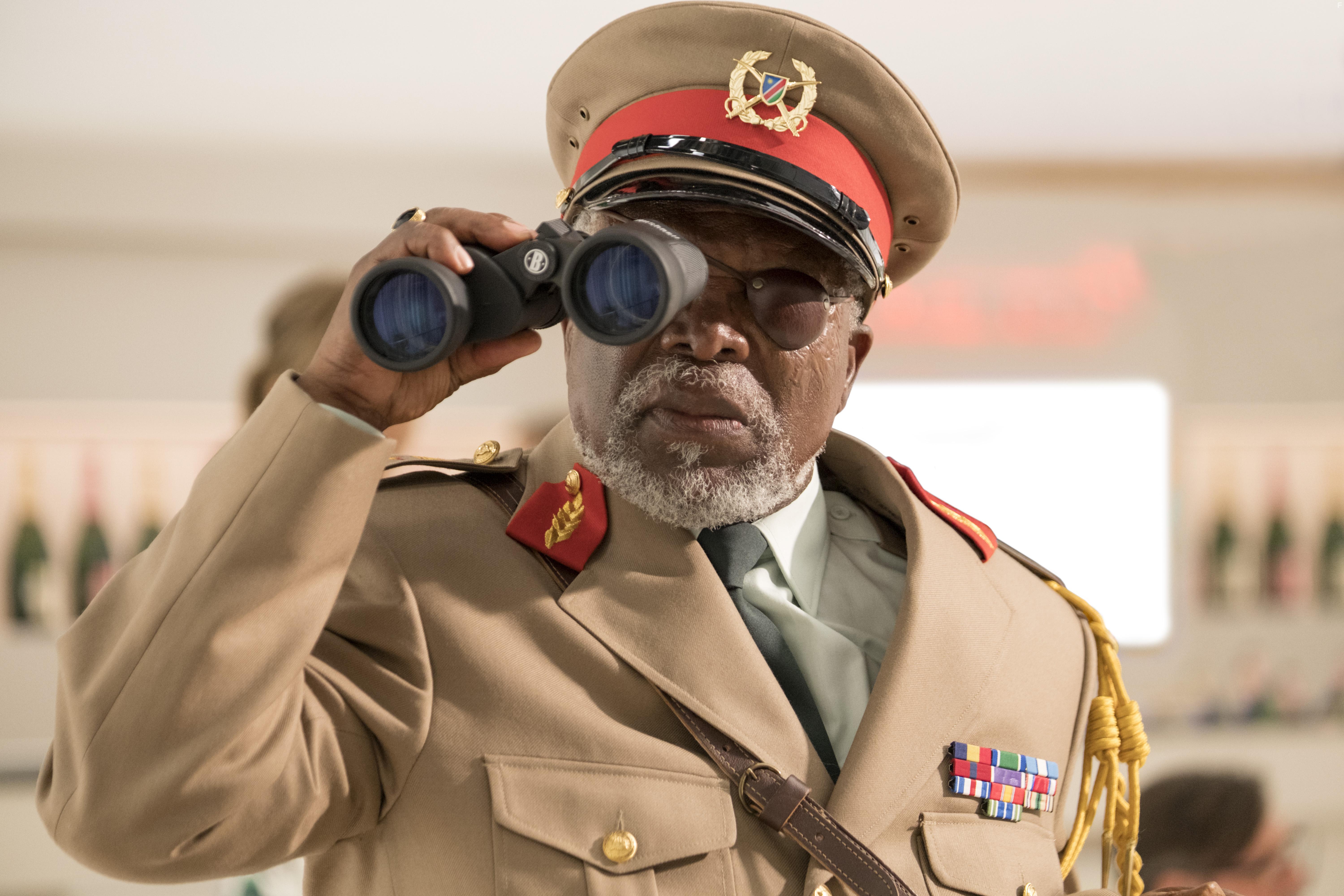 John Kani in Murder Mystery (2019)