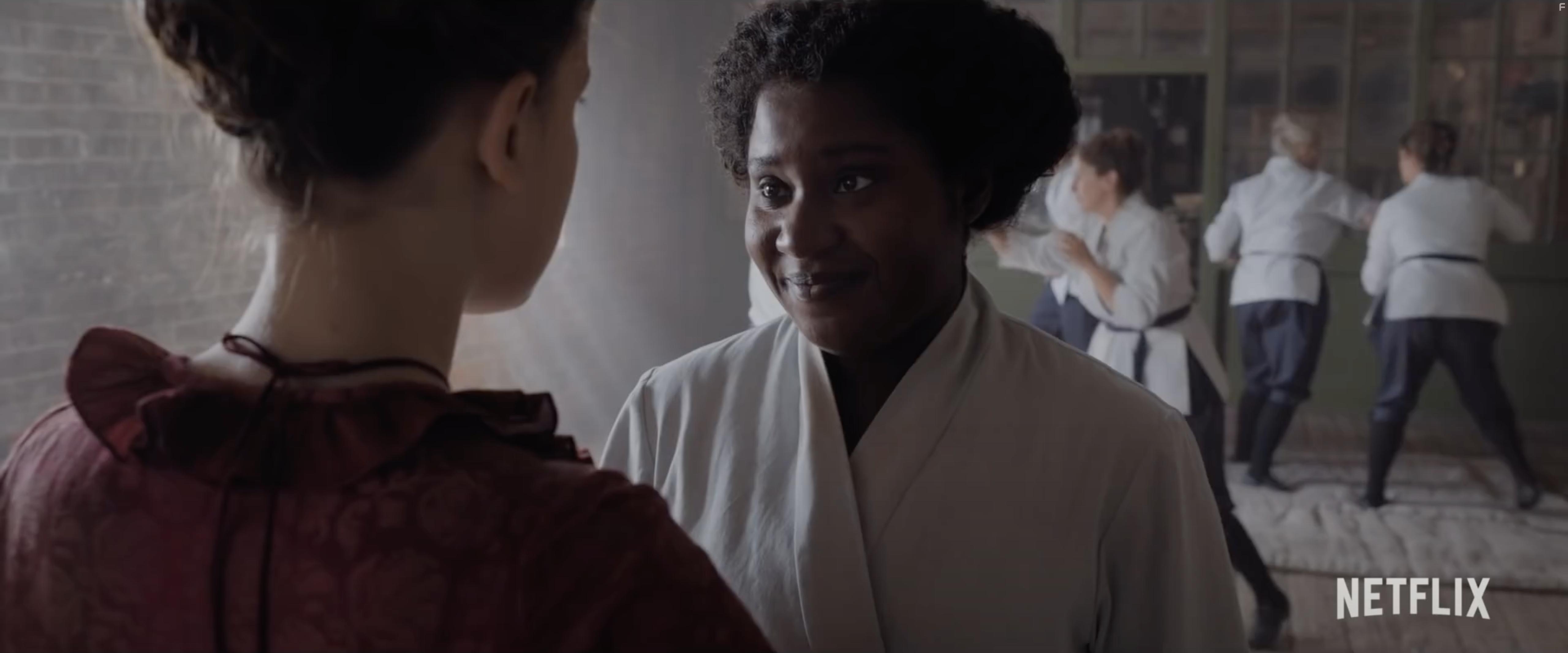 Susan Wokoma and Millie Bobby Brown in Enola Holmes (2020)