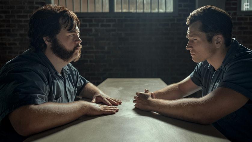 Paul Walter Hauser and Taron Egerton in Black Bird (2022)