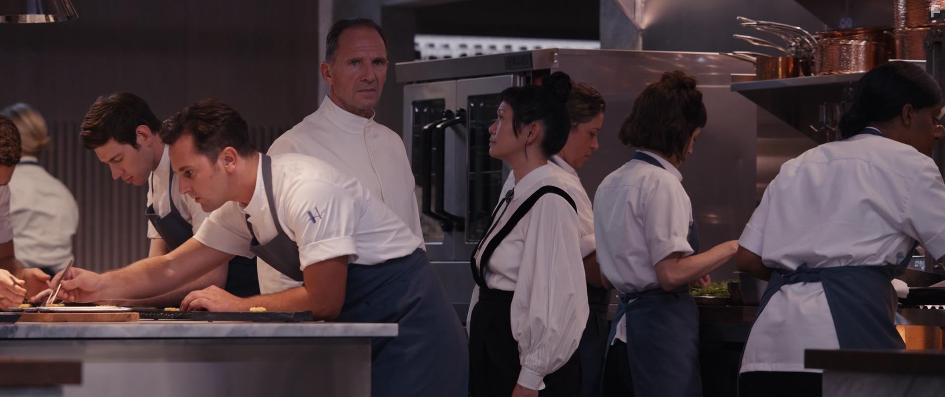 Ralph Fiennes, Christina Brucato, and Hong Chau in The Menu (2022)