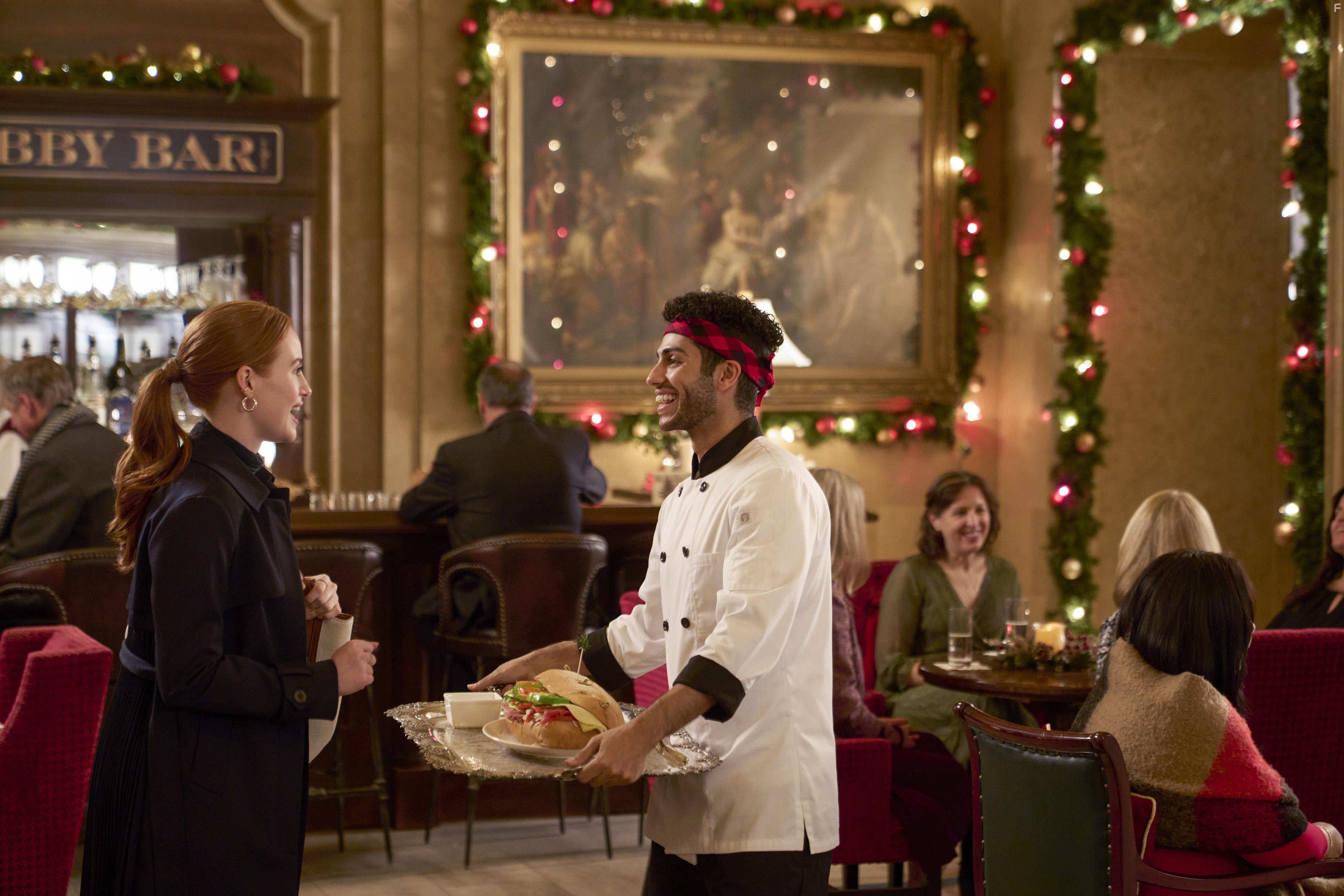 Mena Massoud and Madelaine Petsch in Hotel for the Holidays (2022)