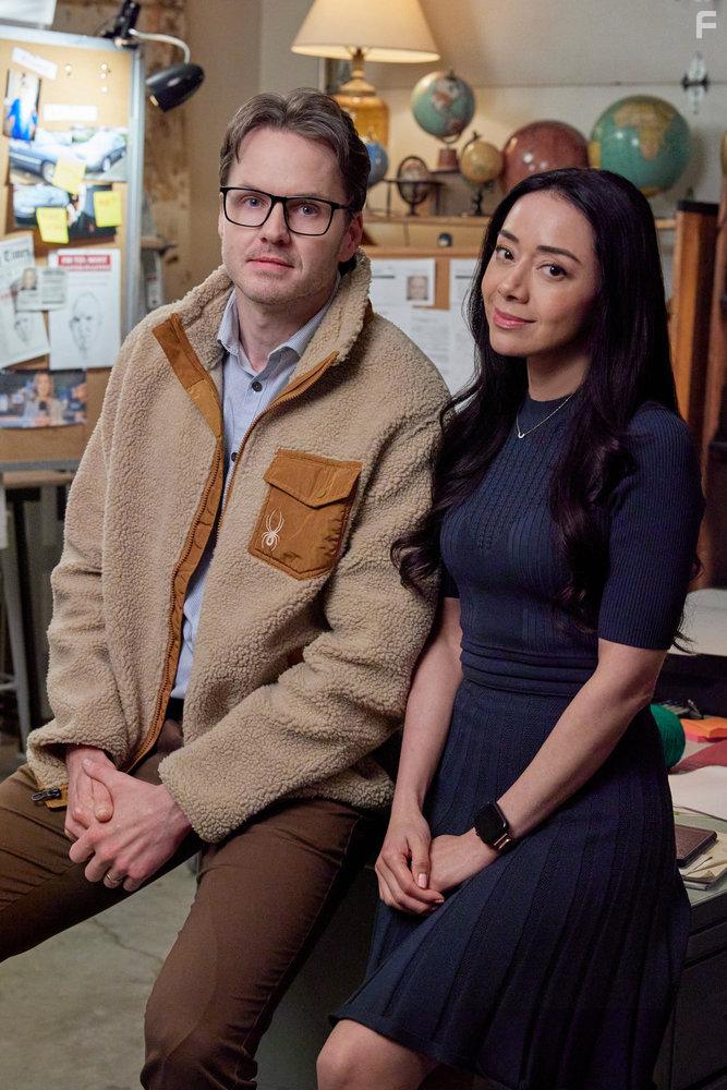 Aimee Garcia and Paul Campbell in The Cases of Mystery Lane (2023)