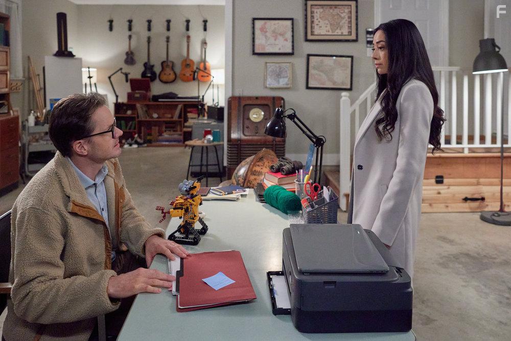 Aimee Garcia and Paul Campbell in The Cases of Mystery Lane (2023)