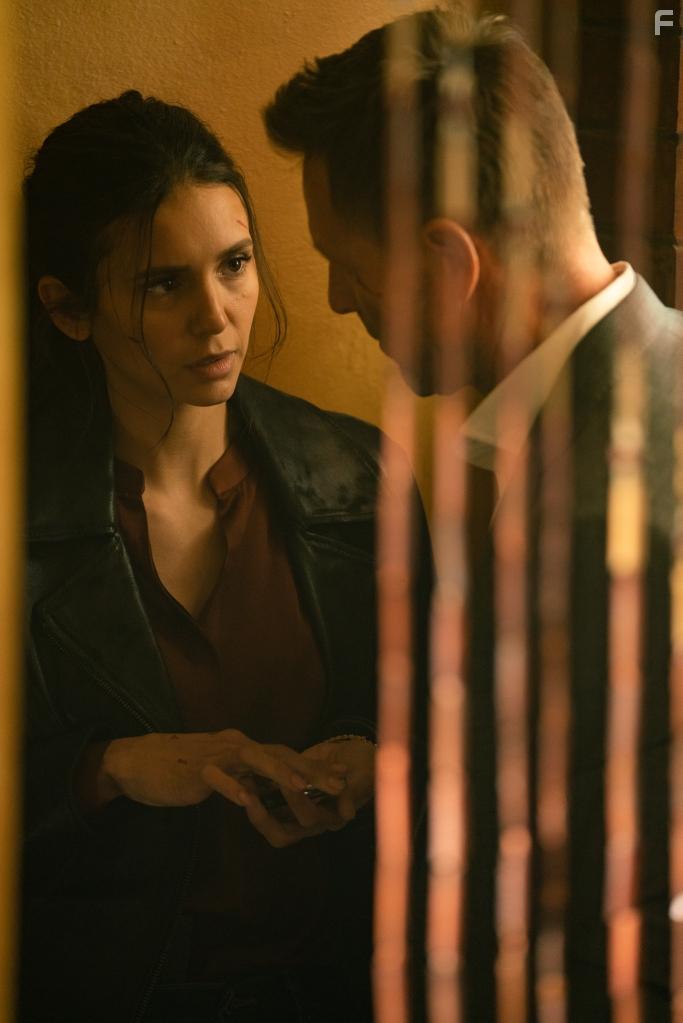 Aaron Eckhart and Nina Dobrev in The Bricklayer (2023)