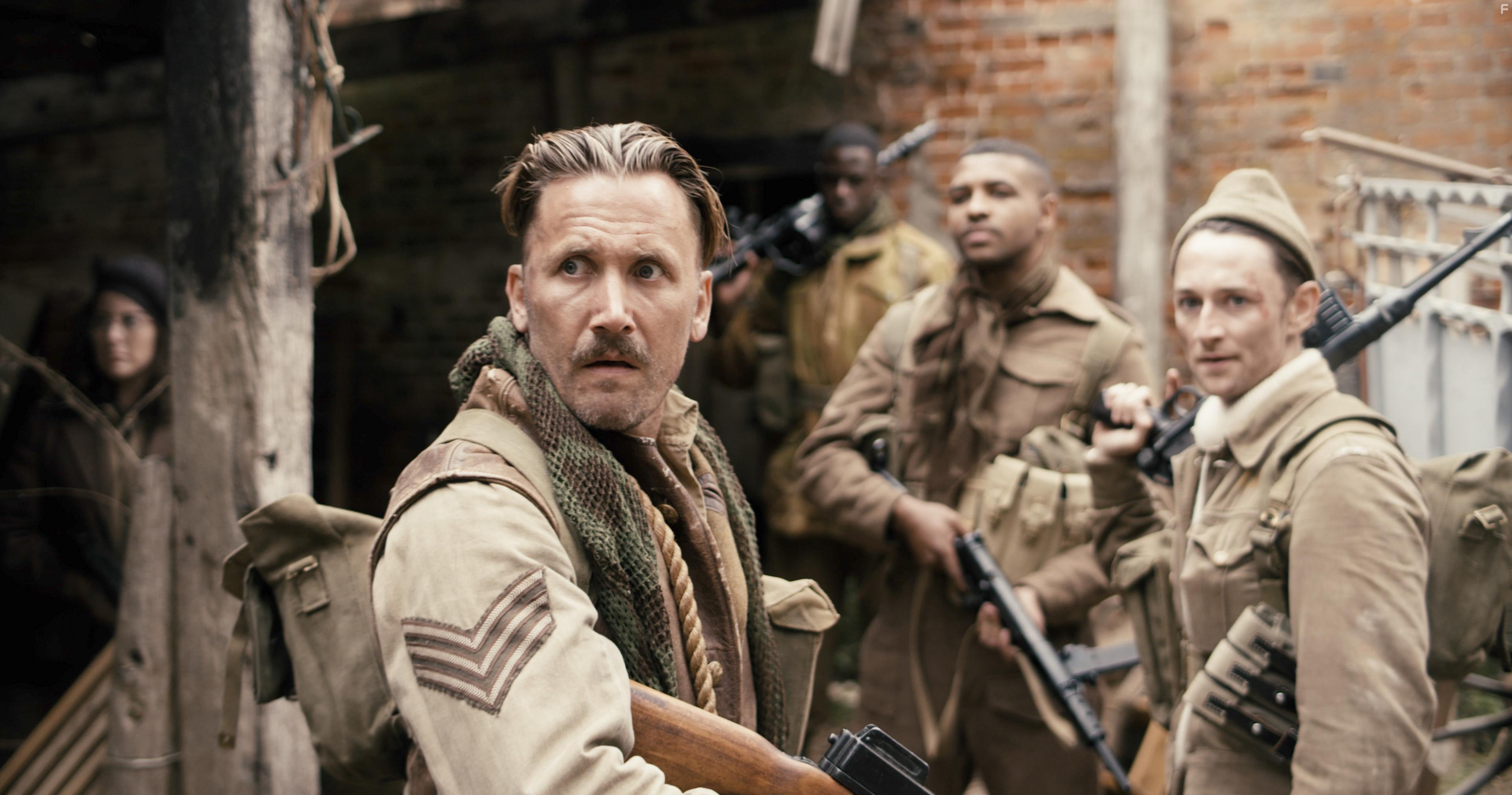 Max Gates, James Oliver Wheatley, Asan N'Jie, and Daniel Thrace in Fortunes of War (2024)