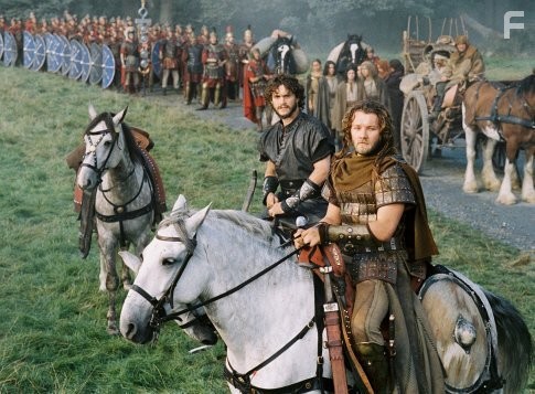 Arthur's Knights of the Round Table, including Galahad (Hugh Dancy, center) and Gawain (Joel Edgerton, right) stand ready to protect the traveling caravan.