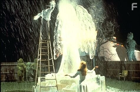 Kim watches Edward carve an ice sculpture