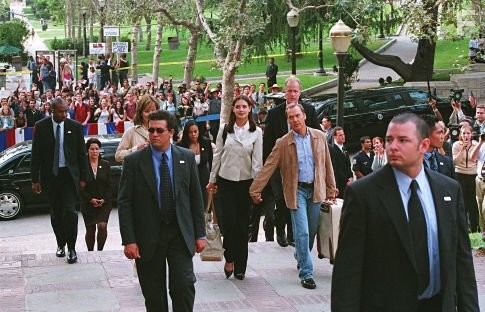 On her first day at college, First Daughter Samantha Mackenzie (Katie Holmes, center, left) is accompanied by her dad - the President of the United States (Michael Keaton) - and a team of Secret Service agents.