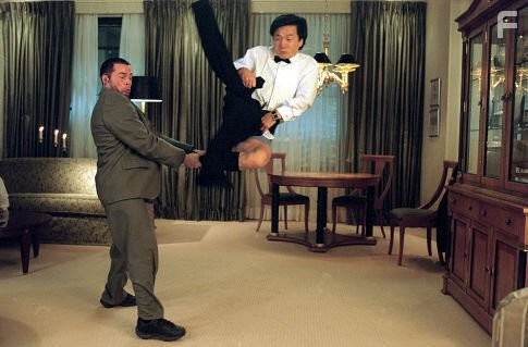 Jimmy Tong (JACKIE CHAN, right) almost gets caught with his pants down in a fight with one of Banning's henchmen (BRADLEY JAMES ALLEN, left)