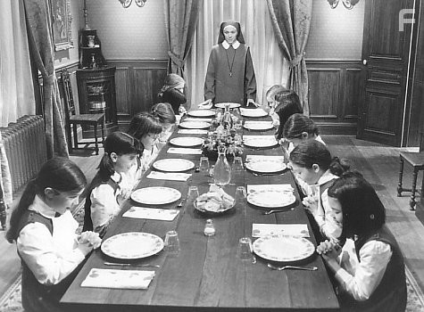 Miss Clavel (Frances McDormand) leads the girls in prayer before their evening meal.