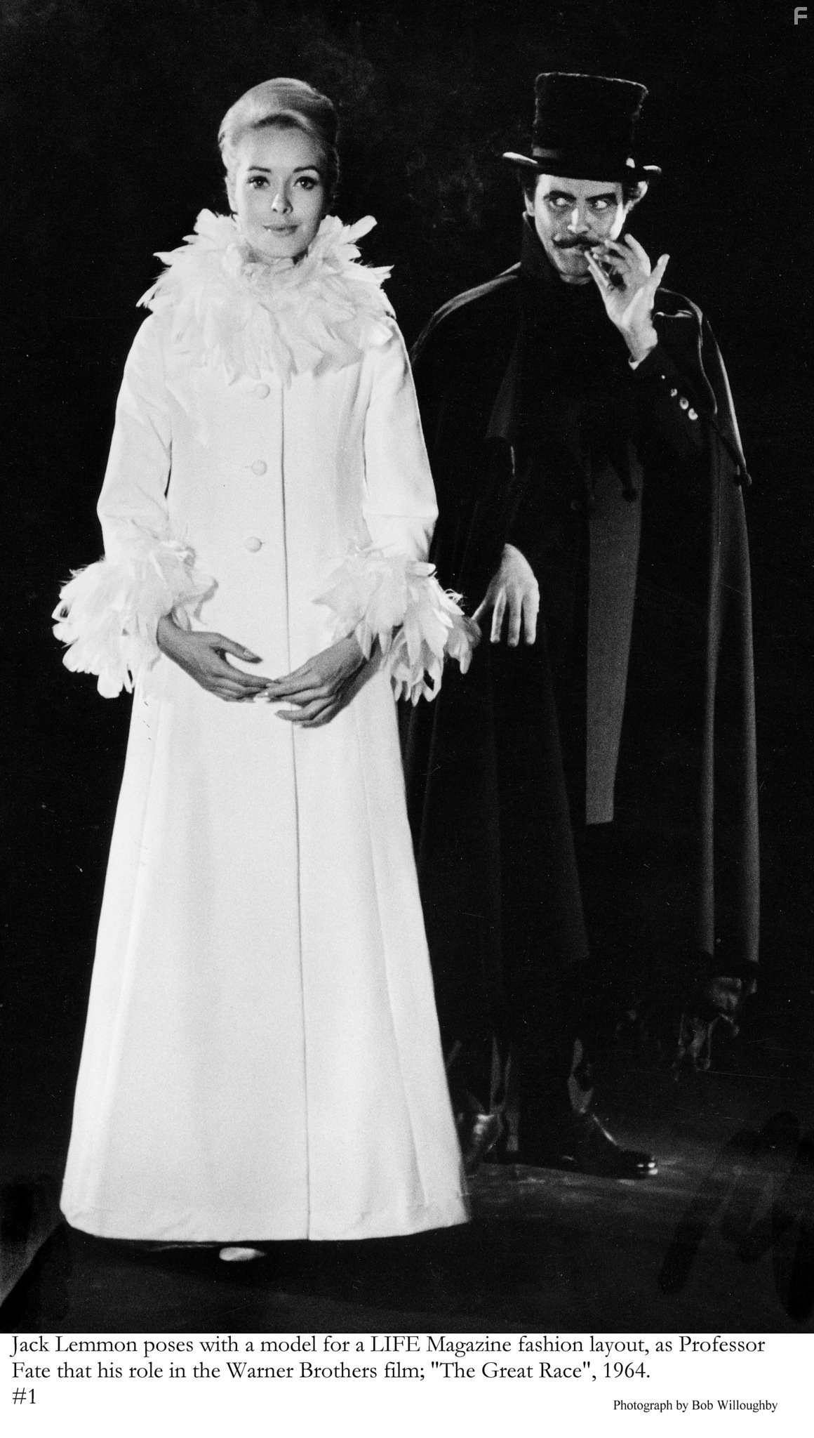 Jack Lemmon in character as Professor Fate in Warner Bros. film "Great Race, The" posing with model for LIFE magazine.