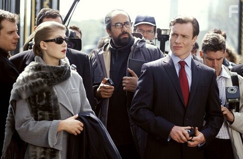 Miranda Frost (ROSAMUND PIKE) and Gustav Graves (TOBY STEPHENS) front a press conference.