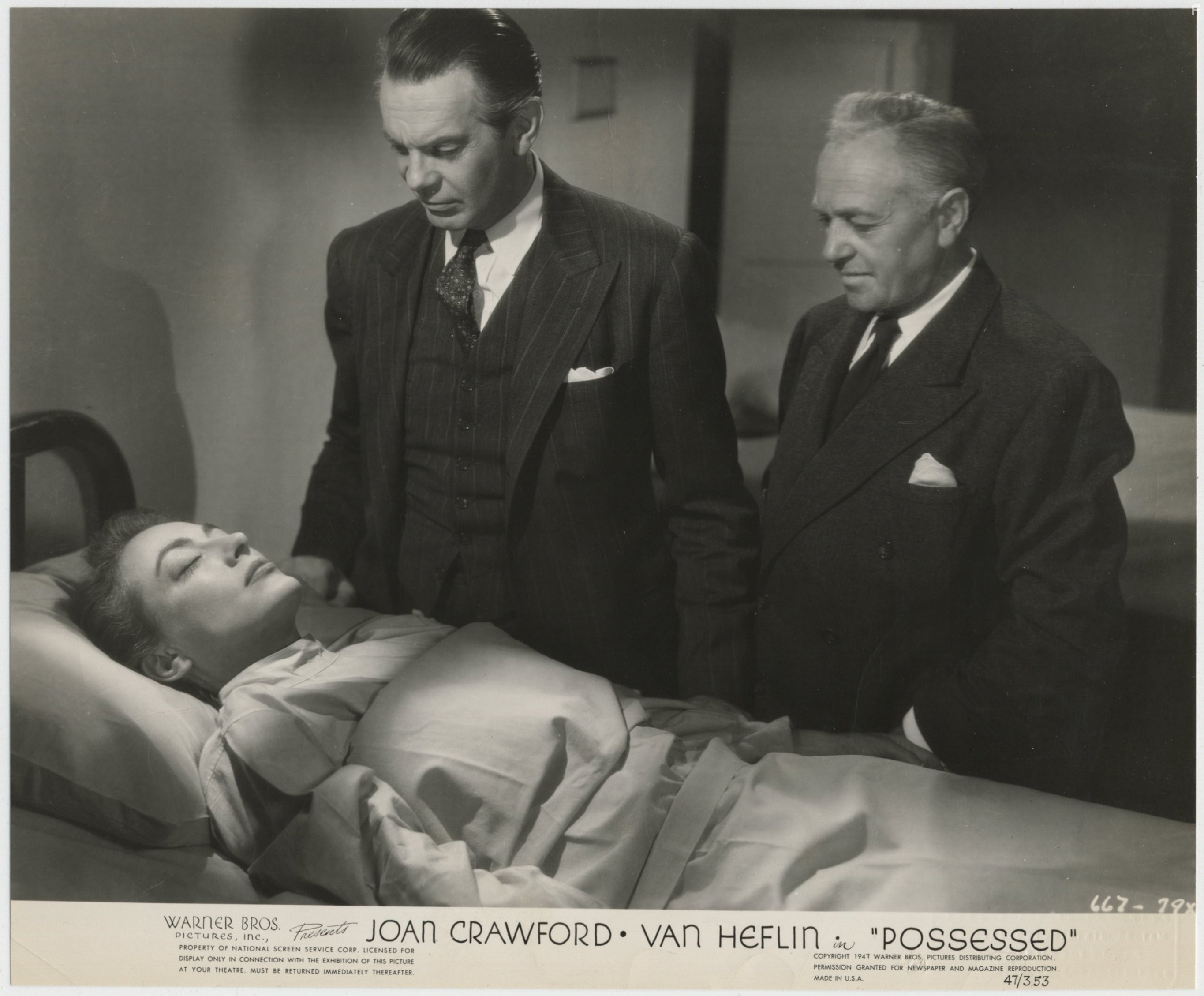 Joan Crawford and Raymond Massey in Одержимая (1947)