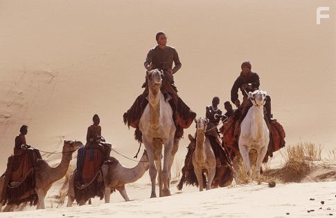 (Center) Heath Ledger as Harry, (left center) Alek Wek as Aquol, (right) Daniel Caltagirone as Gustave