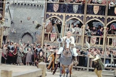 Amid the adrenaline-charged cries of spectators-including (from left to right, background) Kate (Laura Fraser), Chaucer (Paul Bettany) and Roland (Mark Addy), aspiring knight William (Heath Ledger, foreground) rides into fame