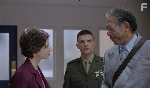 Grimes (MORGAN FREEMAN) cautions the defiant Claire (ASHLEY JUDD) to play by the military court's rules (a warning Grimes himself often ignores), as Embry (ADAM SCOTT) looks on.