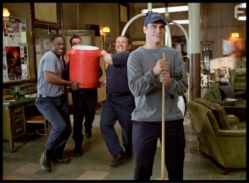 Rookie firefighter Jack Morrison (Joaquin Phoenix, right) gets a "shower" from firehouse comrades Don Miller (Kevin Daniels. Left), Captain Mike Kennedy (John Travolta, center left) and Frank McKinney (Kevin Chapman, center right).