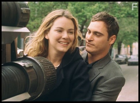 Newly married, Linda (Jacinda Barrett, left) and Jack Morrison (Joaquin Phoenix, right) share a ride on the back of the Ladder 49 fire truck.