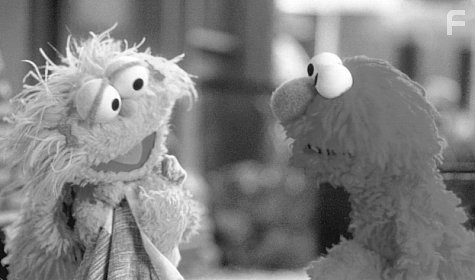 Elmo (right) goes on an adventure to find his cherished blue blanket when it gets lost in Grouchland during a game of tug-of-war with his friend Zoe.